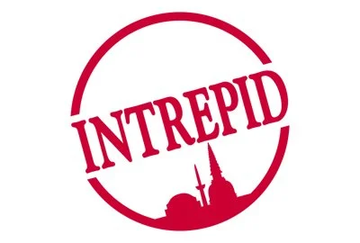 Red circular stamp with the word "INTREPID" and a silhouette of a city skyline.